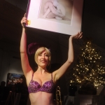 Trixie Minx of Fleur de Tease shows off the Joyce Tenneson photograph up for bid at the PhotoNOLA gala at the New Orleans Museum of Art in New Orleans December 10 2009.
