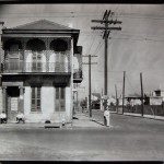 WALKER EVANS: Greek Revival Townhouse on Street Corner with Men Seated in Doorway, New Orleans, 1935