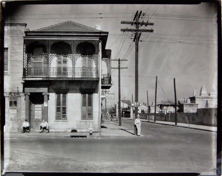WALKER EVANS: Greek Revival Townhouse on Street Corner with Men Seated in Doorway, New Orleans, 1935