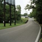 Jessica Ingram, Site of Virgil Ware’s Murder, on the Docena-Sandusky Road, outside Birmingham, Alabama - Virgil Ware, a 13-year-old boy, was killed on this site on Sept. 15, 1963, while riding on the handlebars of his brother’s bicycle.
While riding by on a motorbike with Michael Lee Farley, 16-year old Larry Joe Sims shot at the Ware brothers, hitting Virgil twice.
Sims and Farley had just attended a segregationist rally. They were charged with first-degree murder, but an all-white jury convicted them on the lesser charge of second-degree manslaughter. Judge Wallace Gibson gave the boys two years probation.
In 1997 Michael Lee Farley called the Ware Family to apologize. Sims called in 2003. Jessica Ingram, Site of Virgil Ware’s Murder, on the Docena-Sandusky Road, outside Birmingham, Alabama